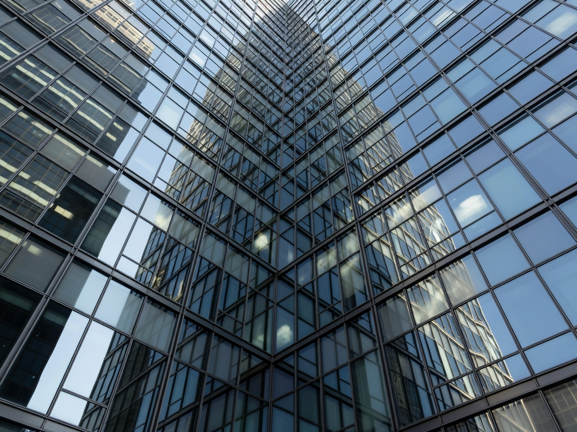 Massive urban architectural skyscraper facade featuring complex matrix patterns of glass and steel.